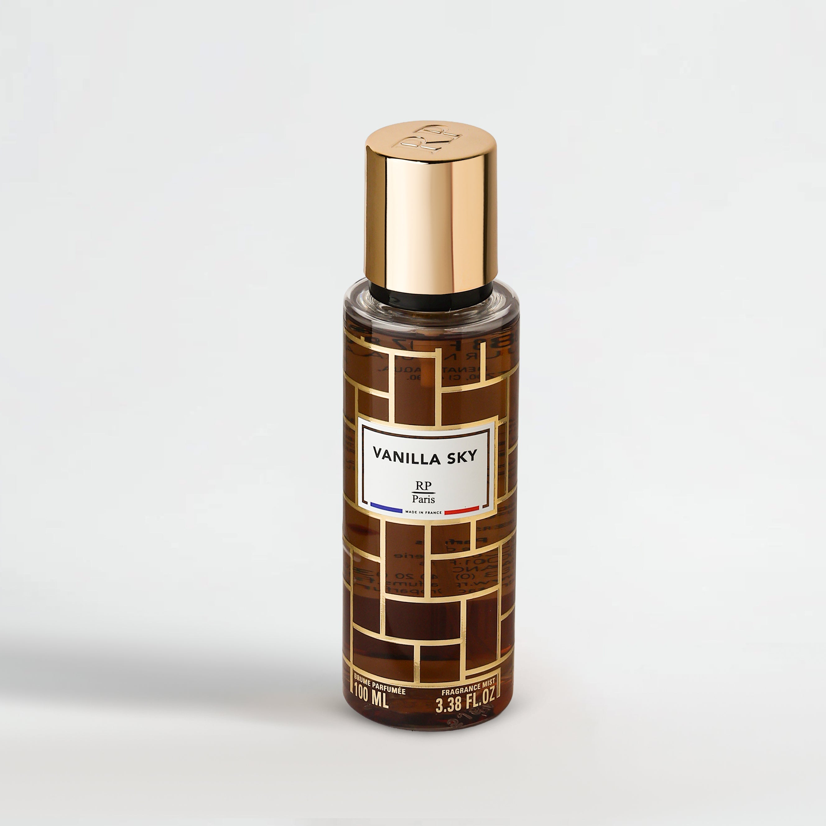 Perfume bottle labeled 'Vanilla Sky' with gold cap on a light gray background