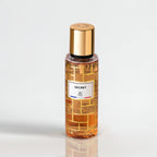 Perfume bottle with gold cap and label on a light gray background