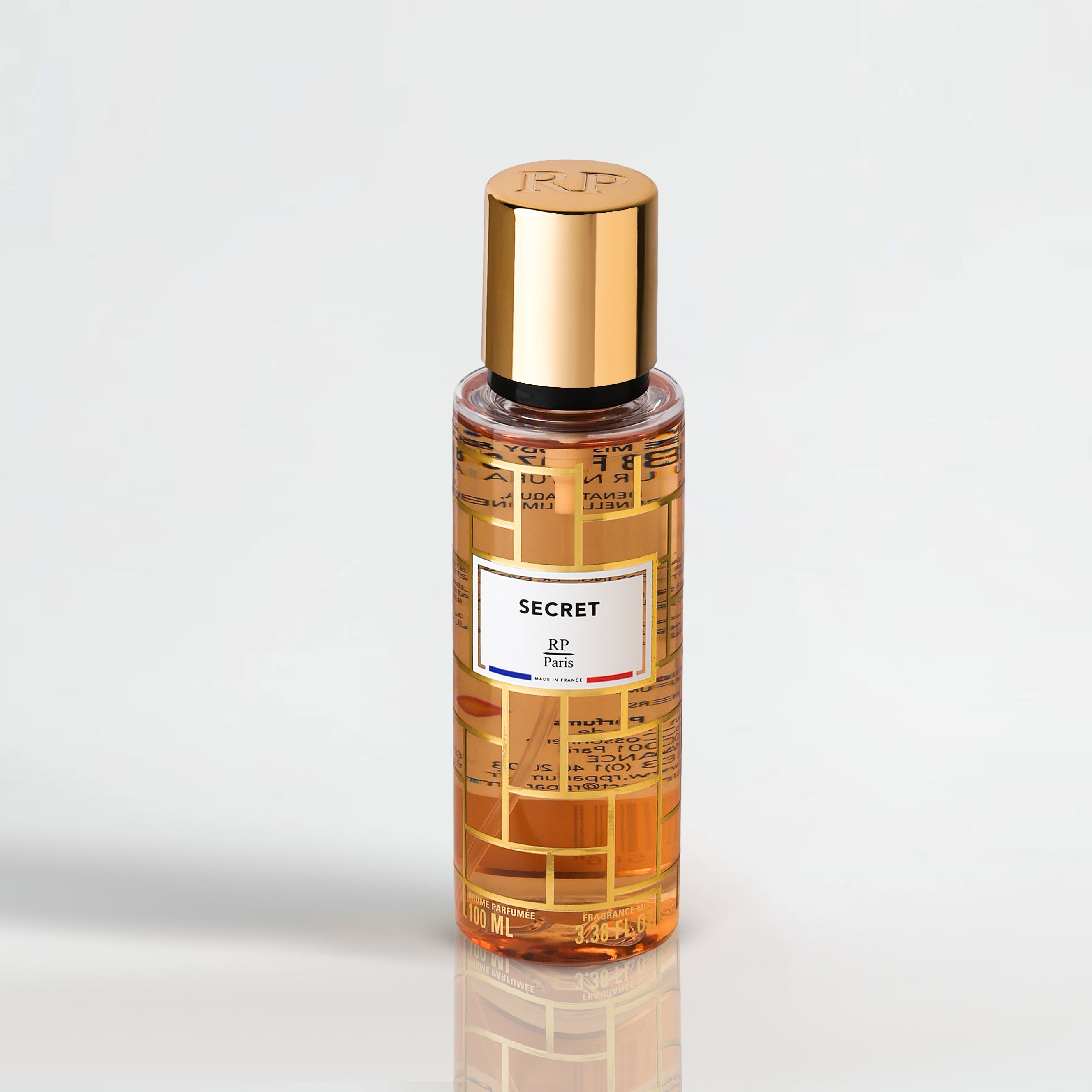 Perfume bottle with gold cap and label on a light gray background
