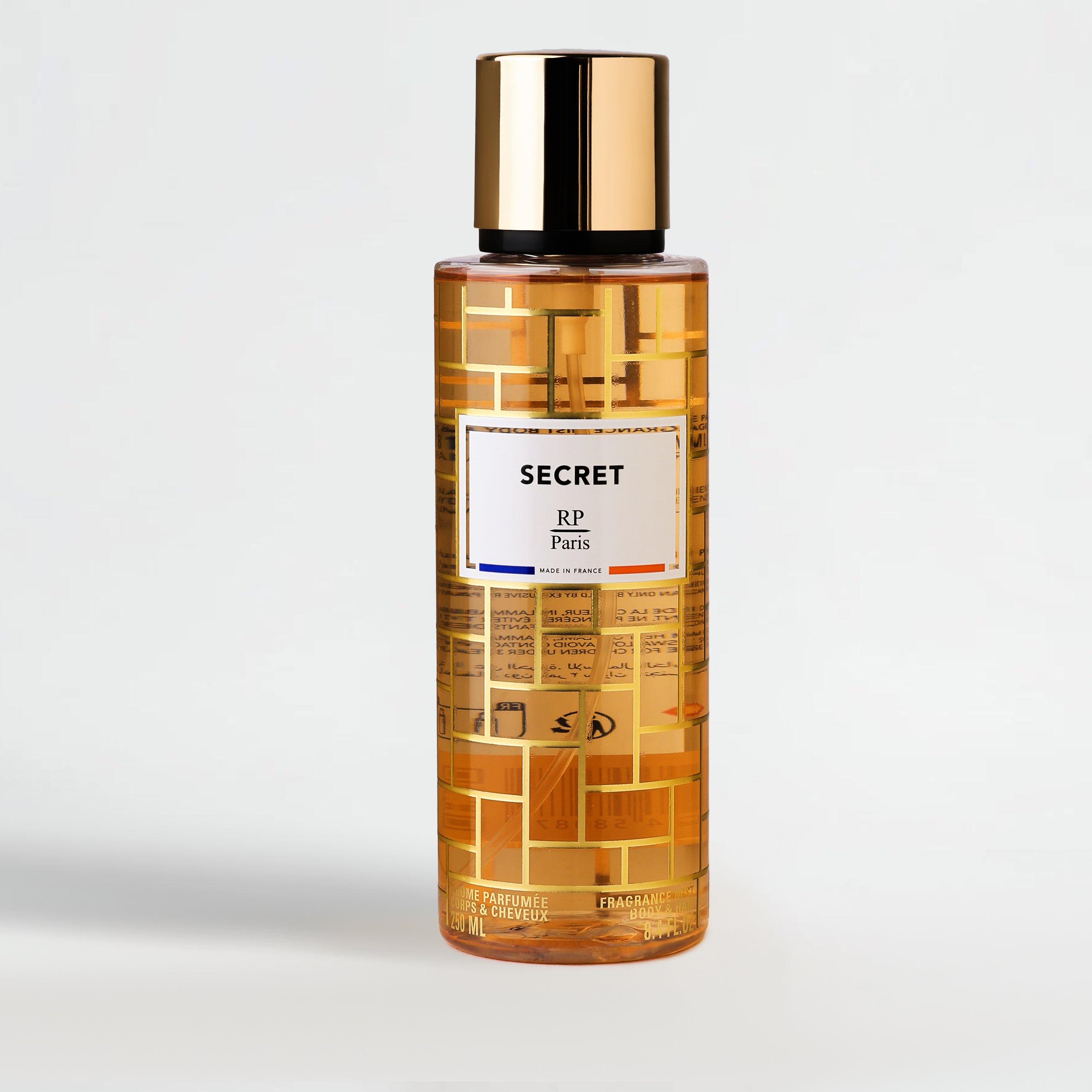 Bottle of Secret RP Paris perfume with gold cap on a light gray background
