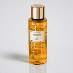 Orange bottle with gold cap labeled 'SECRET RP Paris' on a light gray background