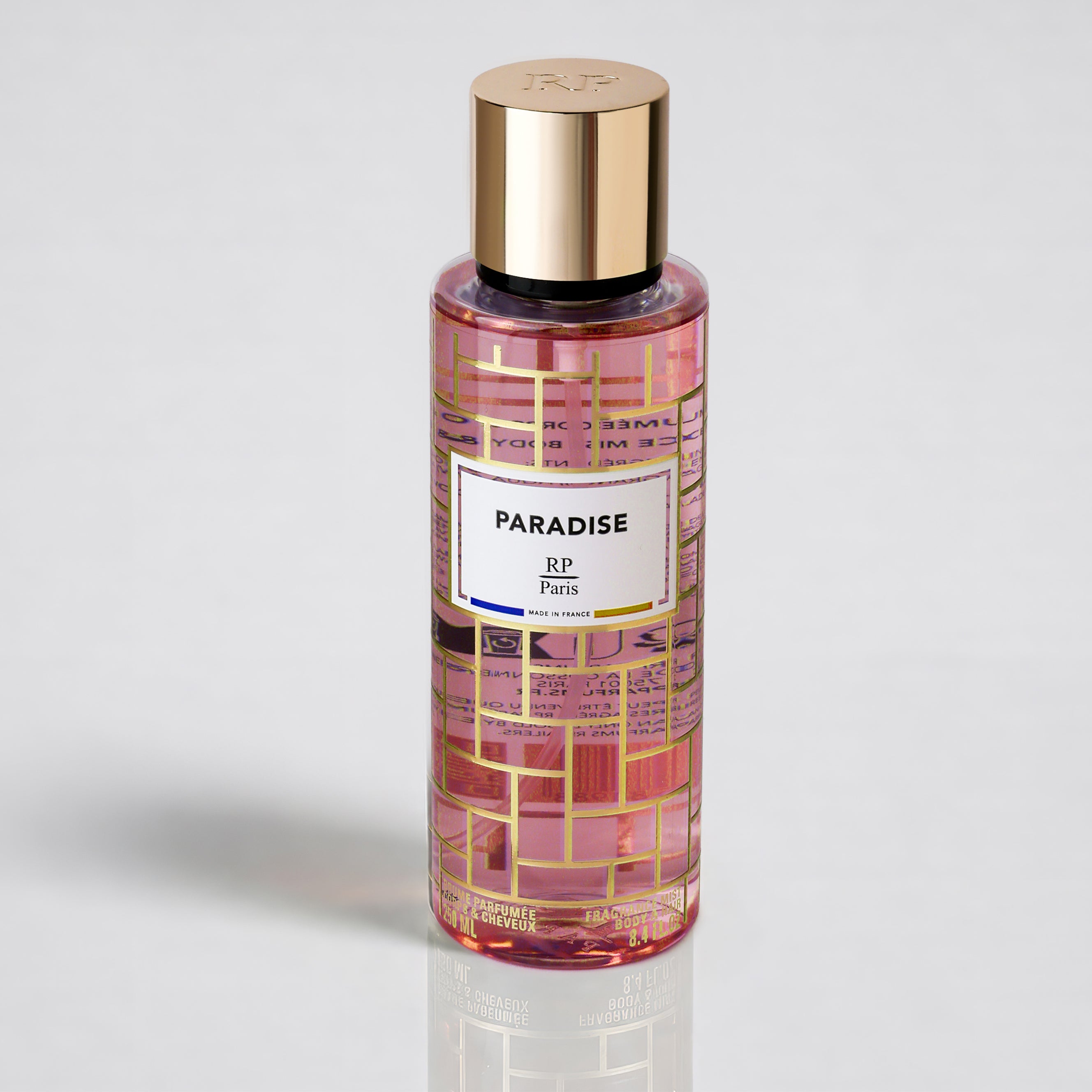 Perfume bottle labeled 'Paradise' with gold cap on a light gray background
