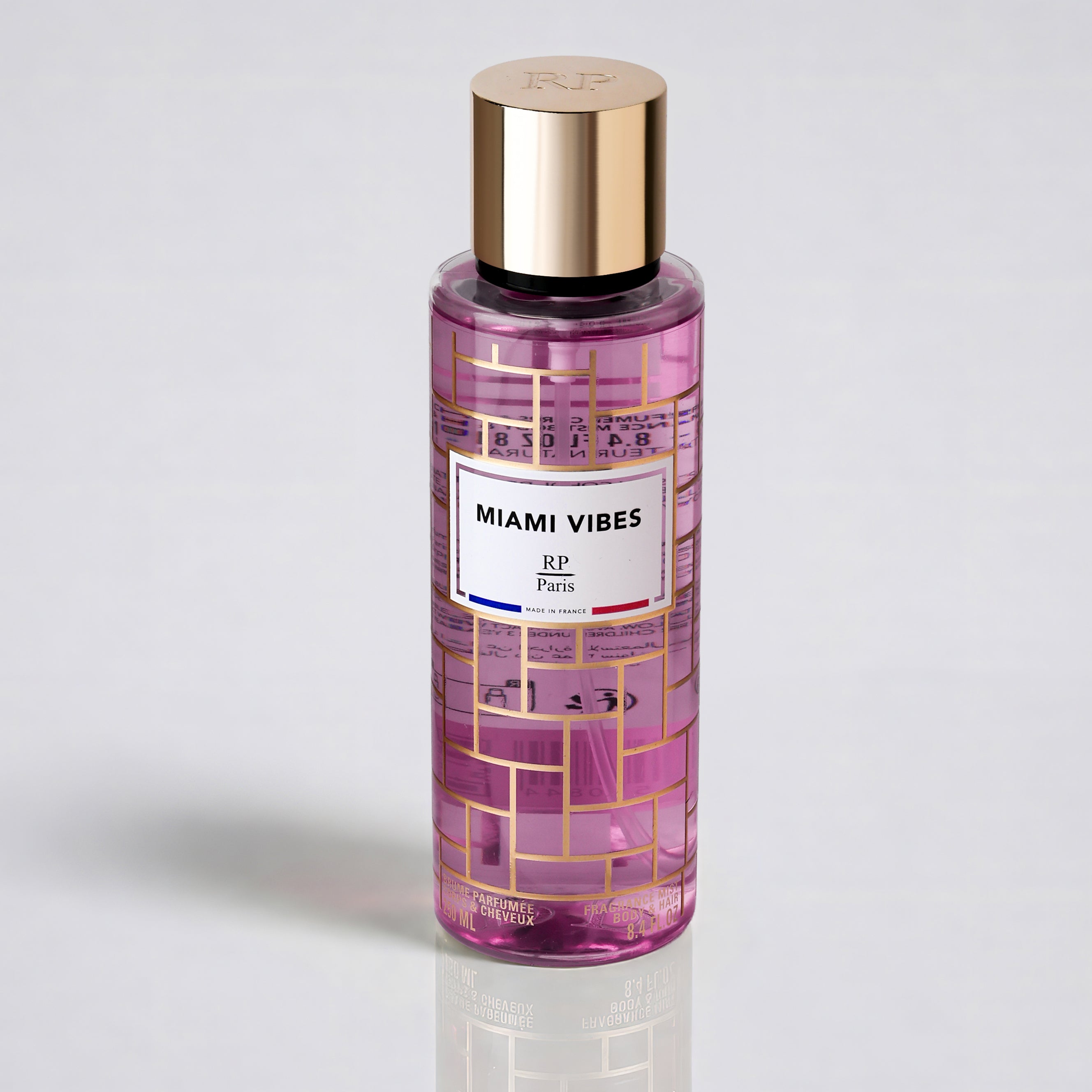 Pink bottle with gold cap labeled 'Miami Vibes' on a light gray background
