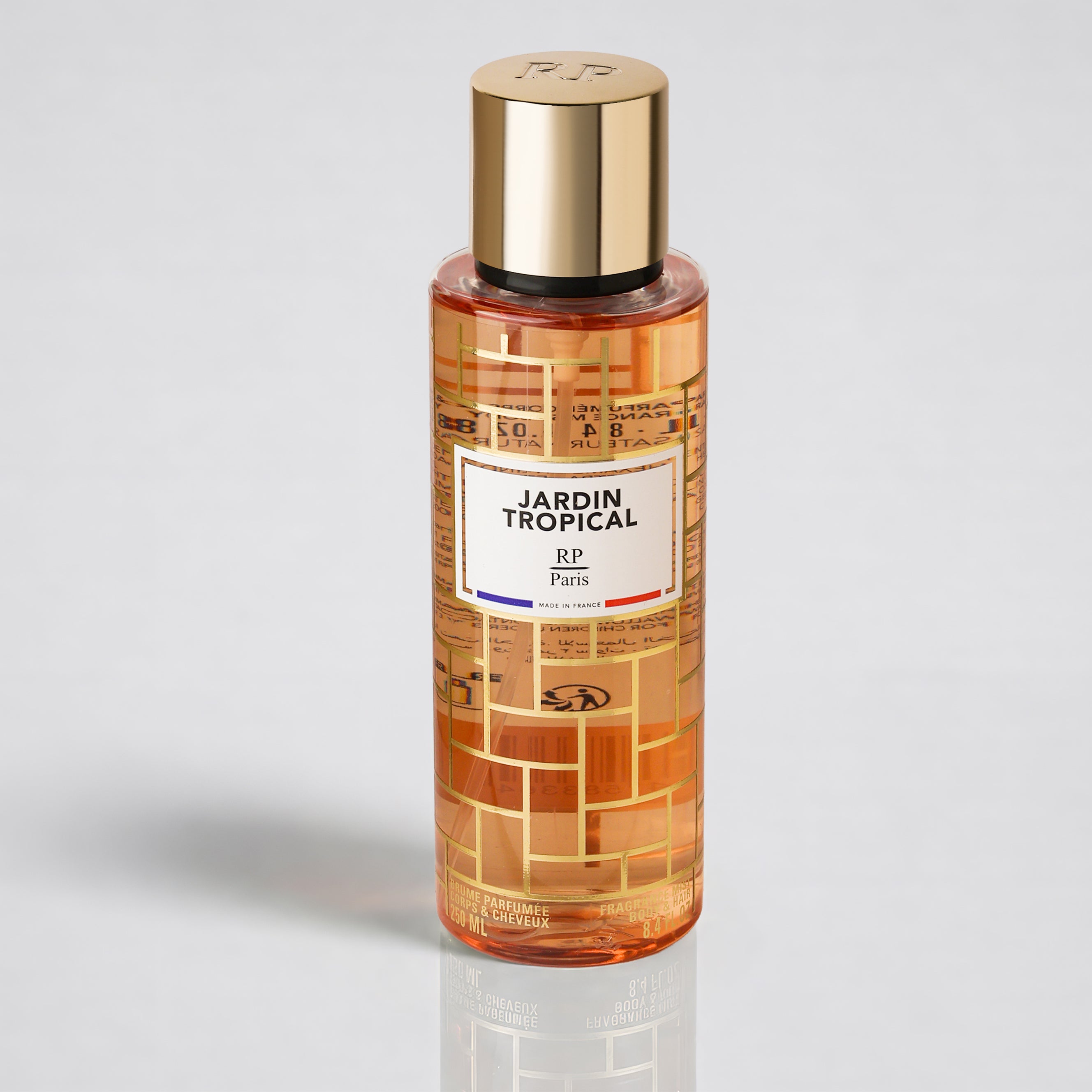 Perfume bottle labeled 'Jardin Tropical' with gold cap on a light gray background