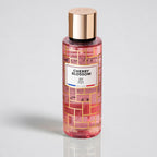 Perfume bottle labeled 'Cherry Blossom' with a gold cap on a light gray background