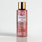 Amber Blush by RP Paris perfume bottle with gold cap and amber fragrance on a light gray background.