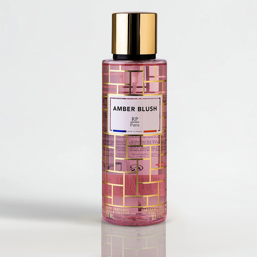 Amber Blush by RP Paris perfume bottle with gold cap and amber fragrance on a light gray background.