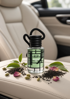 A clear glass car fragrance bottle labeled 'RP London Tea' with green tea leaves inside, placed on a beige leather car seat. The bottle is styled with scattered tea leaves, green cardamom pods, and pink rose petals.