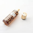 Perfume bottle with gold cap on a white background