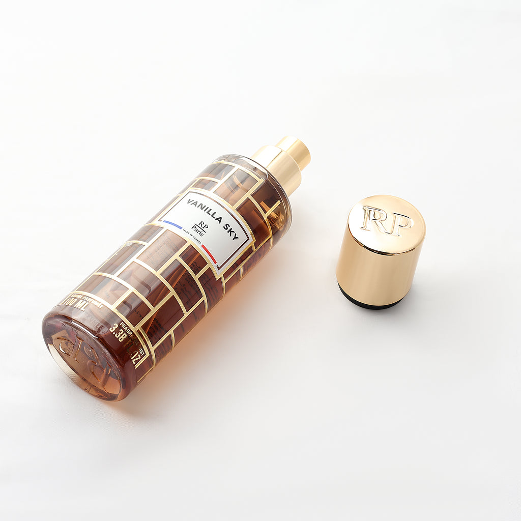 Perfume bottle with gold cap on a white background