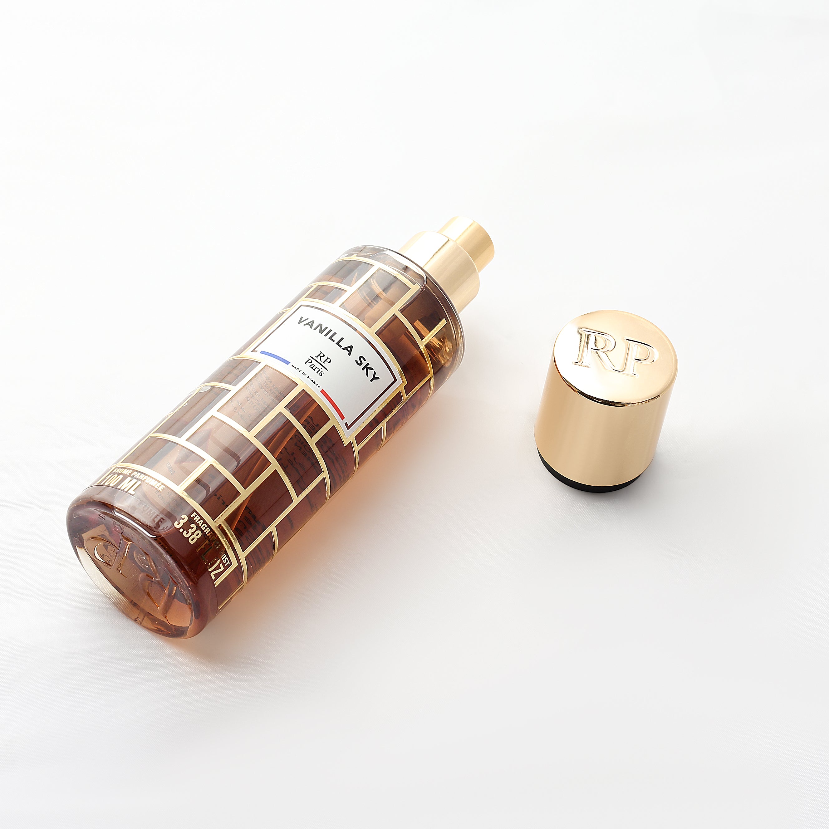 Perfume bottle with gold cap on a white background