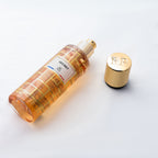 Gold bottle with a label and gold cap on a white background