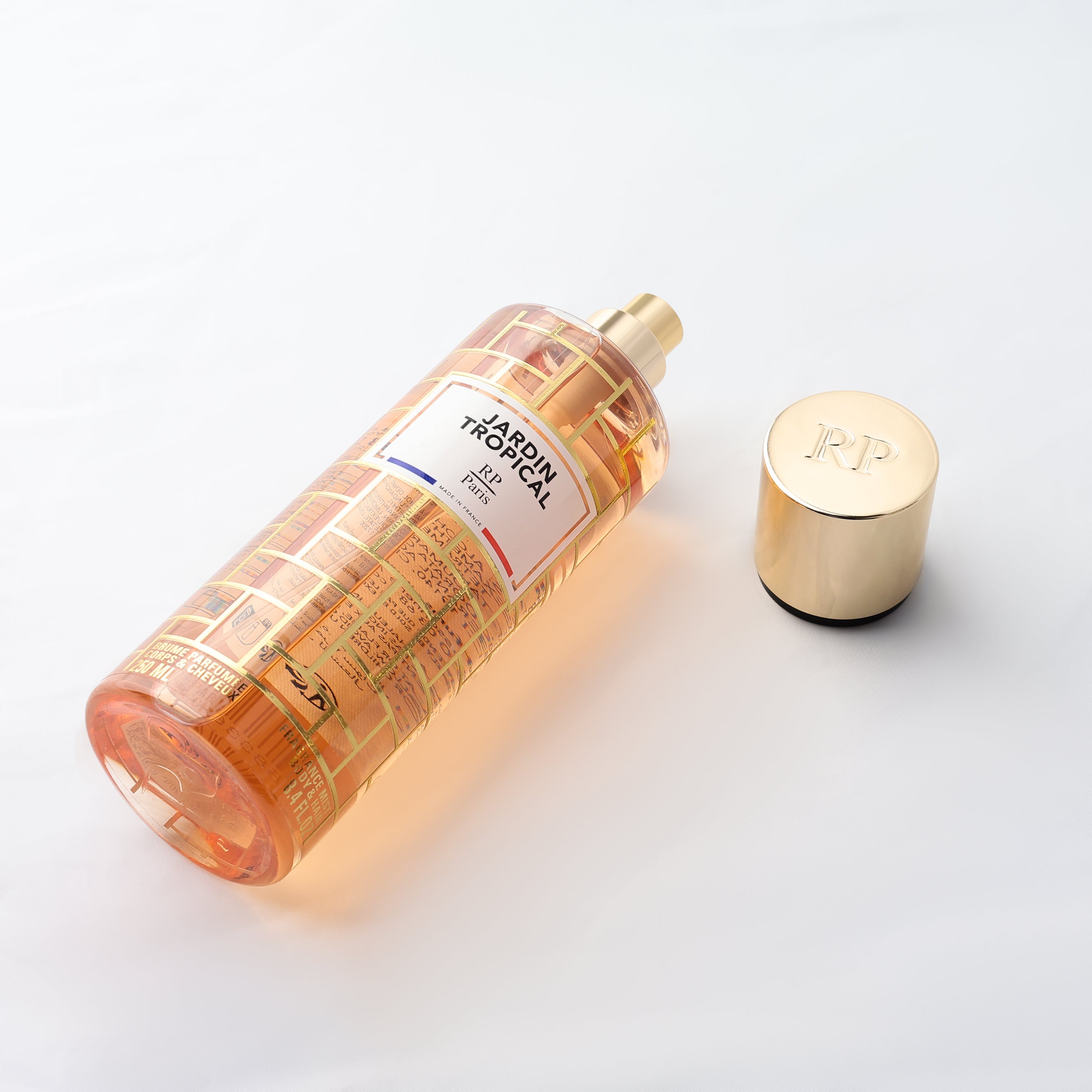 Perfume bottle with gold cap on a light background