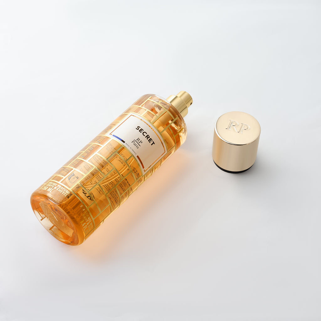 Perfume bottle with gold cap on a white background