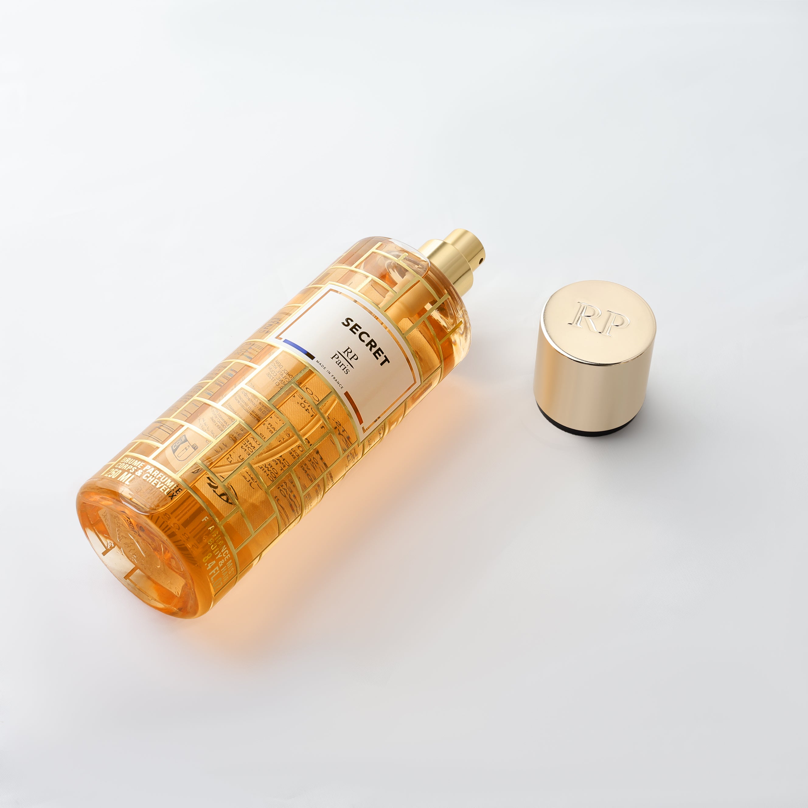 Perfume bottle with gold cap on a white background