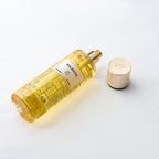 Yellow perfume bottle with gold cap on a white background