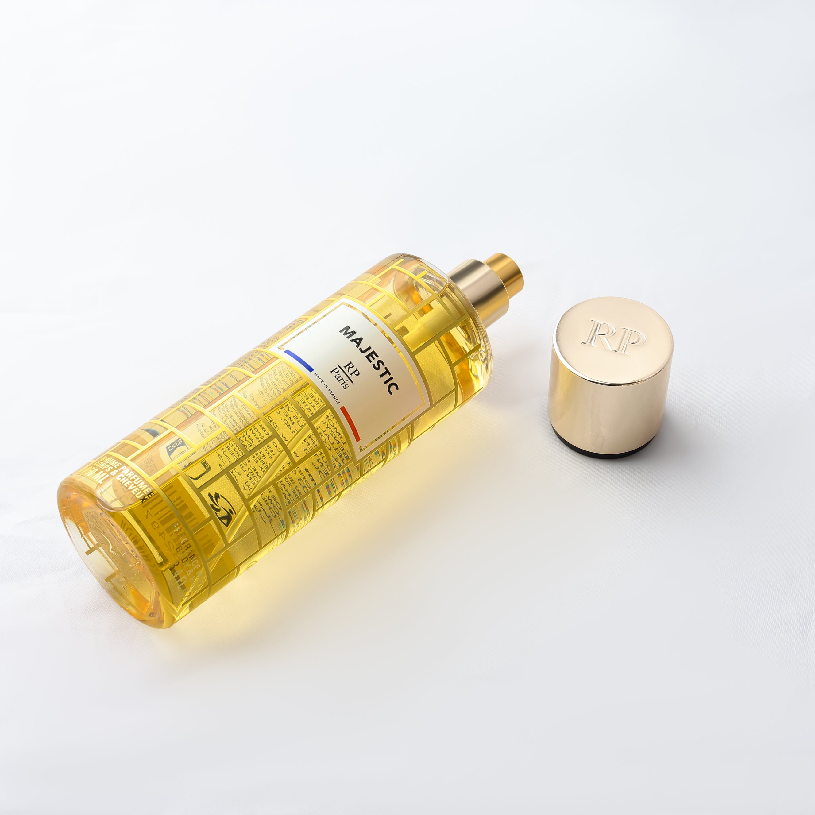 Yellow perfume bottle with gold cap on a white background