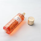 Bella Paris perfume bottle with gold cap on a white background