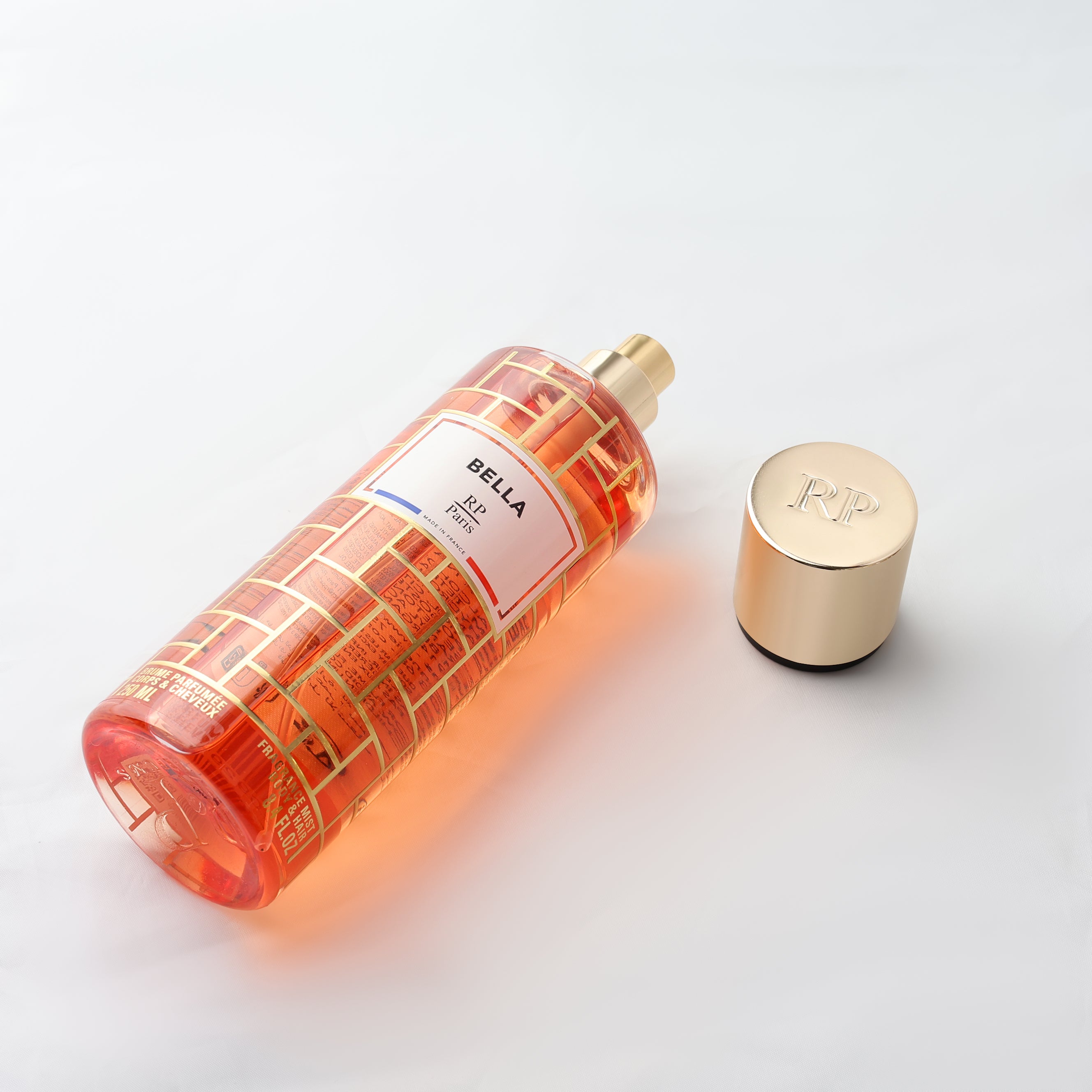Bella Paris perfume bottle with gold cap on a white background