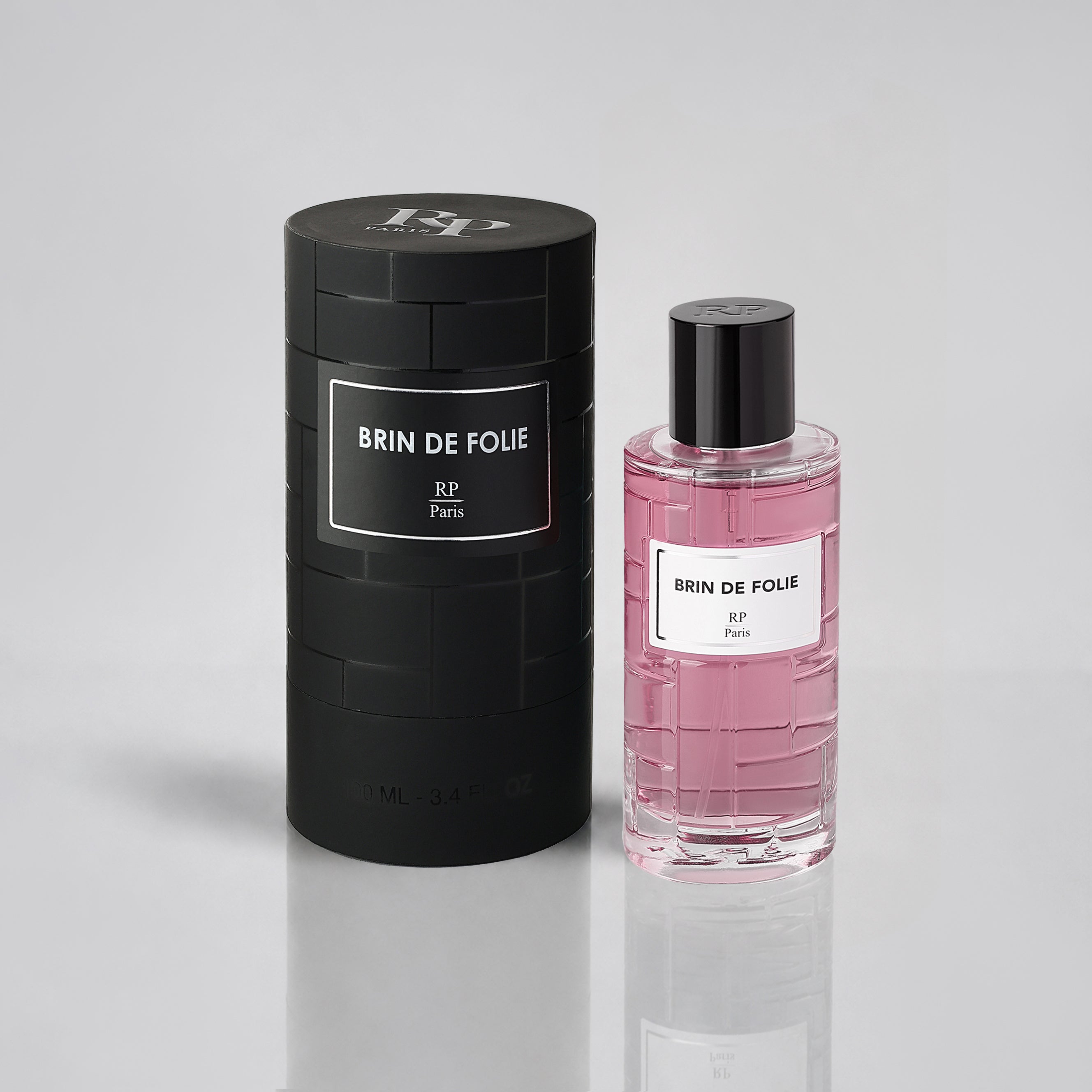 Brin de Folie perfume bottle and packaging on a light gray background