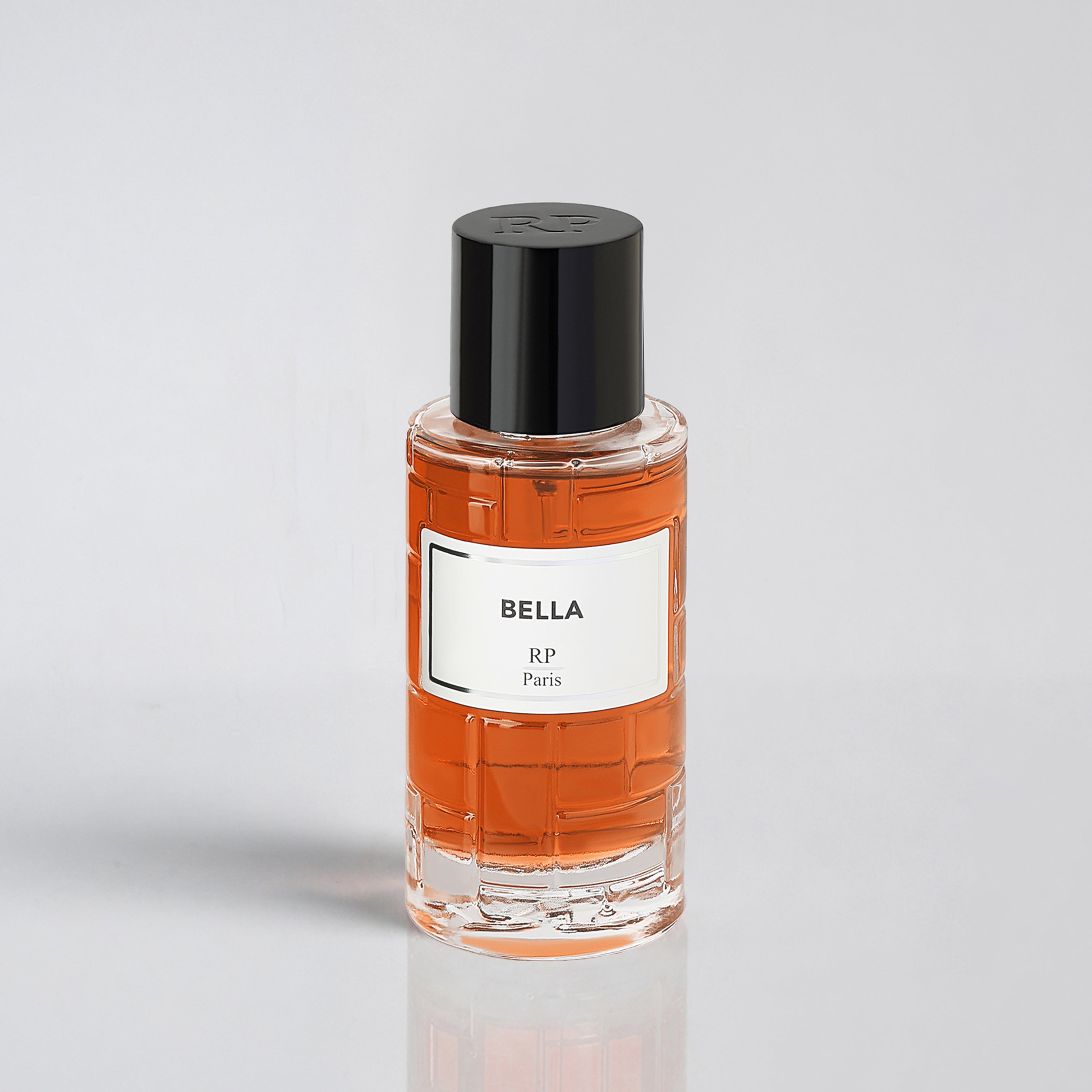 Perfume bottle labeled 'Bella RP Paris' on a light gray background