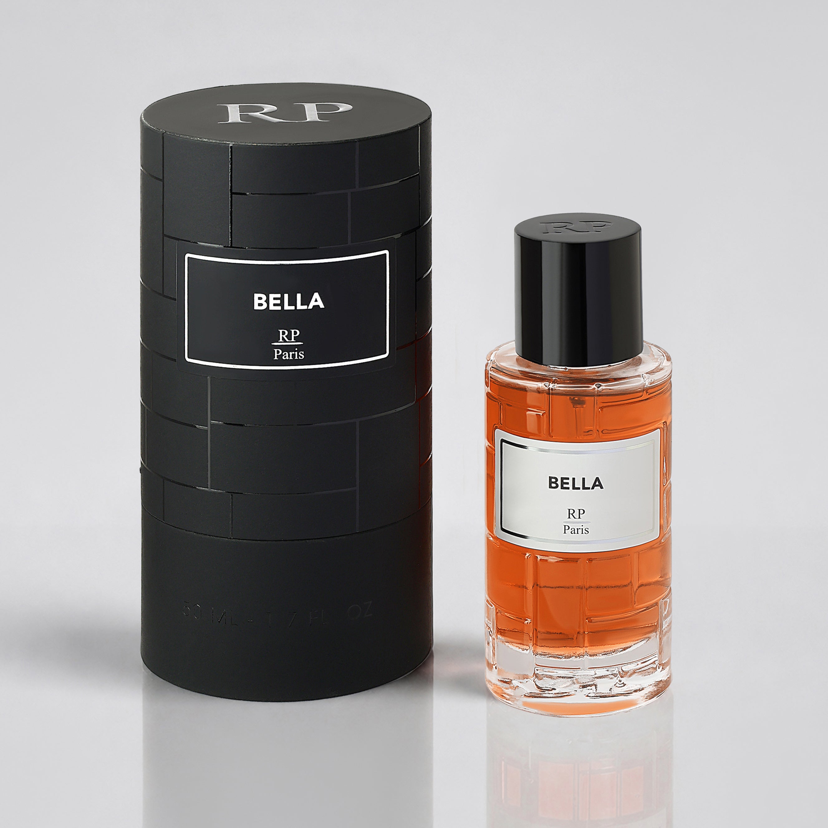 Perfume bottle and packaging labeled 'Bella' by RP Paris on a light gray background