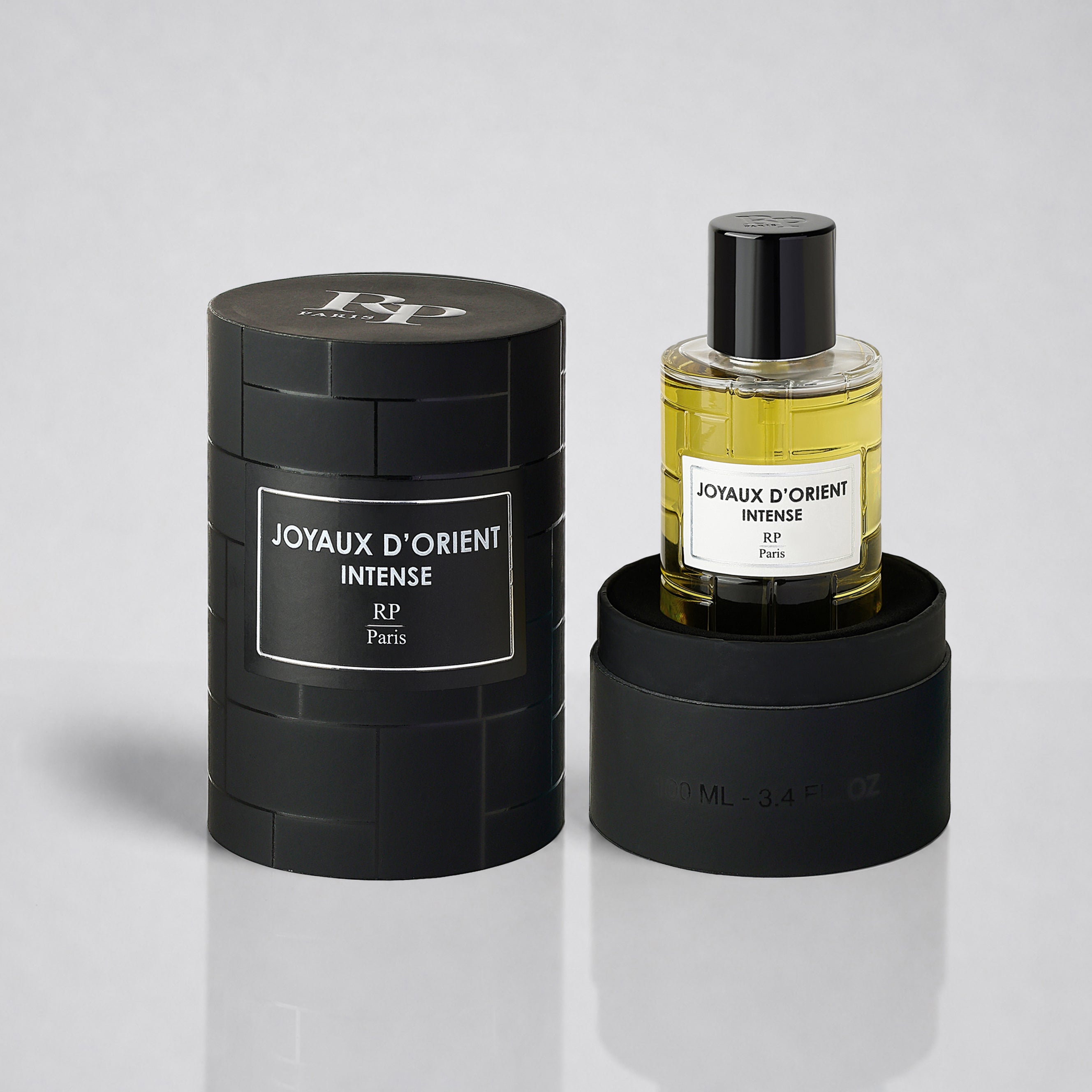 Perfume bottle and packaging of 'Joyaux d'Orient Intense' by RP Paris on a gray background