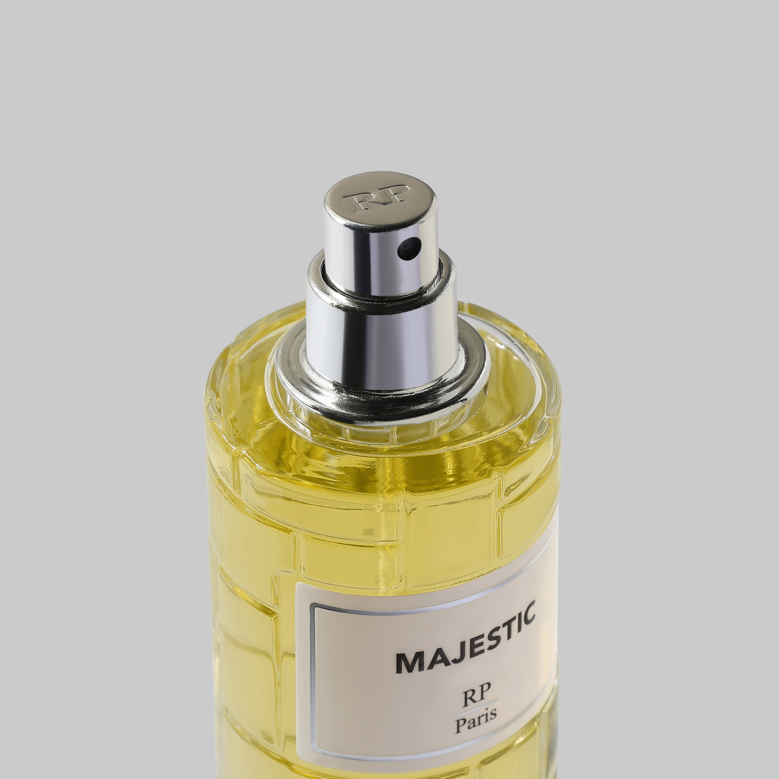 Perfume bottle labeled 'Majestic' by RP Paris on a gray background
