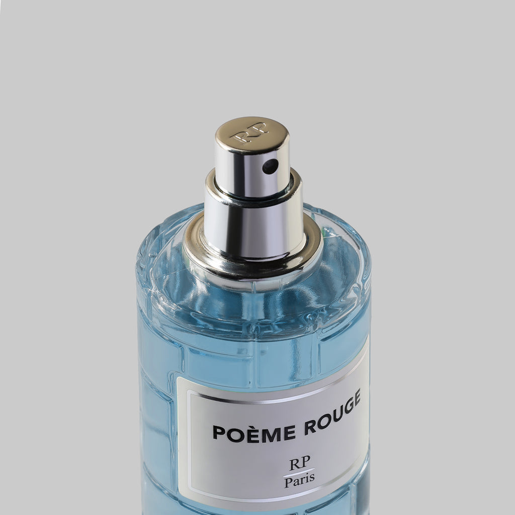 Perfume bottle labeled 'Poème Rouge' on a gray background