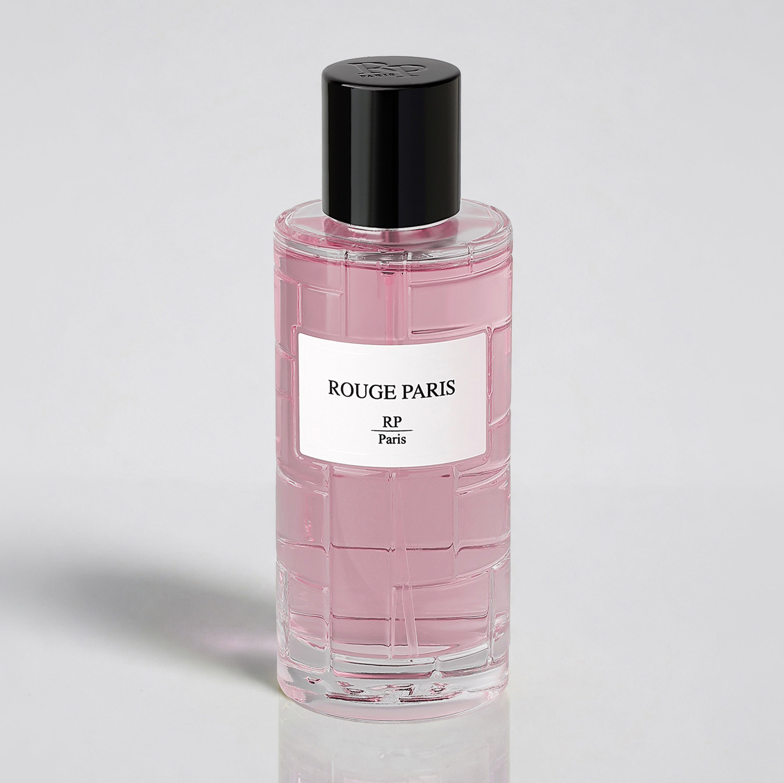 Pink bottle of Rouge Paris with a black cap on a light gray background