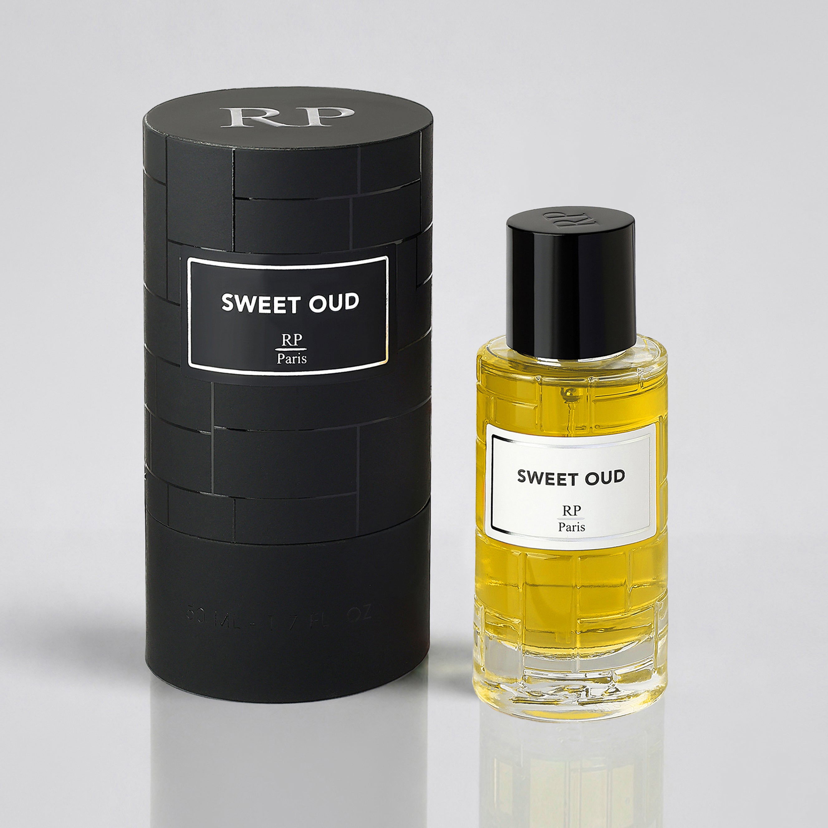 Sweet Oud perfume bottle and packaging on a light gray background