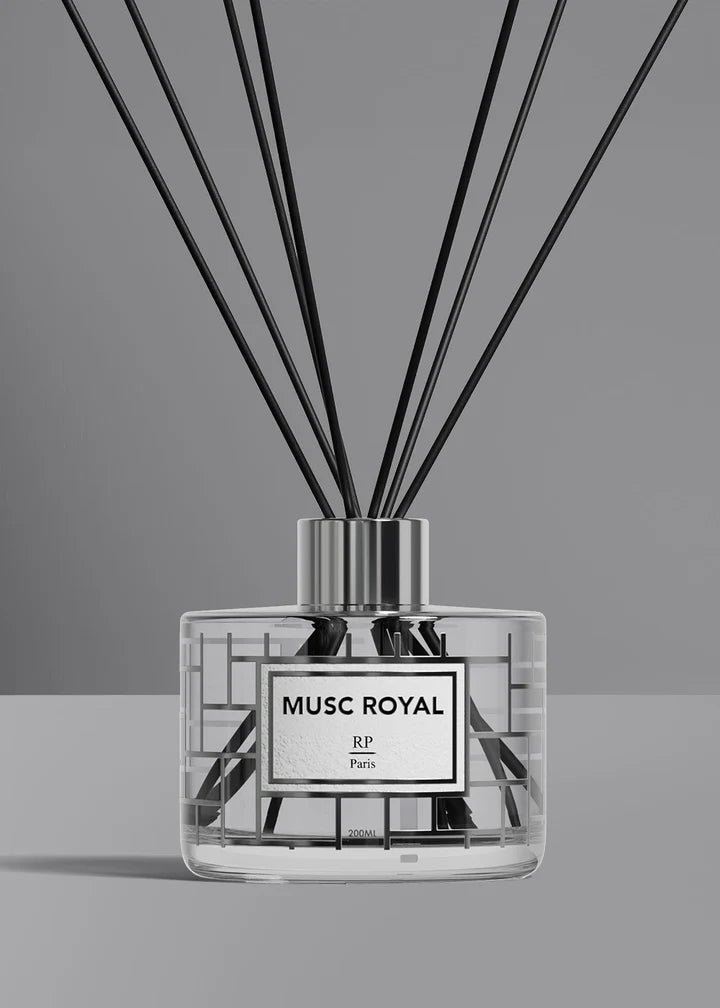 A reed diffuser bottle with a clear glass body, black reeds, and a silver cap, featuring a white label with black text that reads 'MUSC ROYAL JP Paris'.