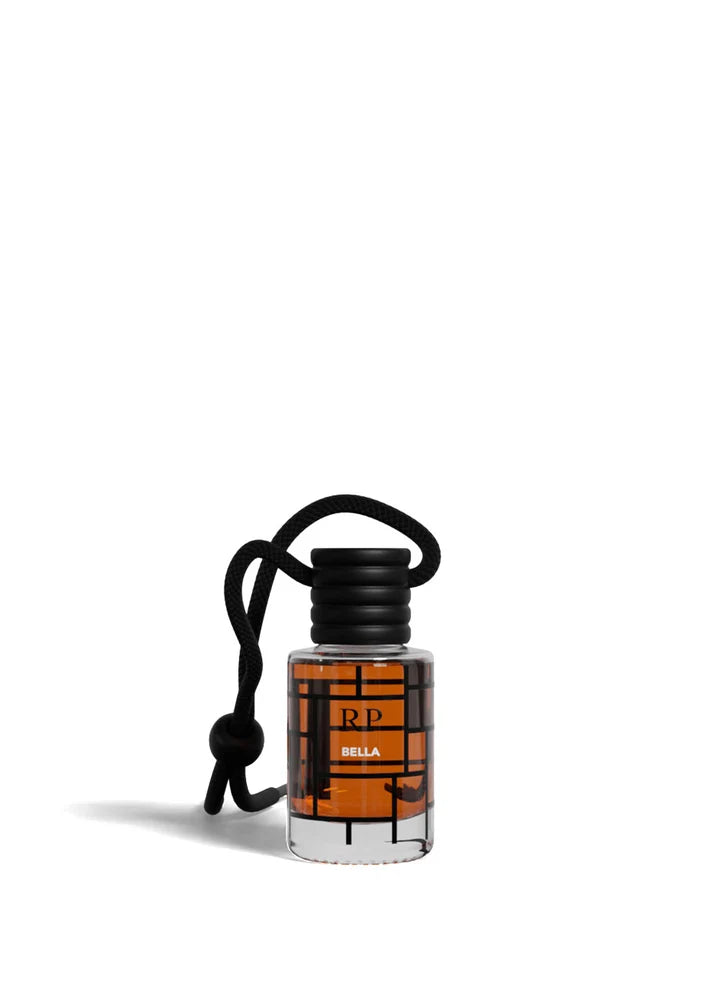 A small clear bottle with amber liquid, a black cap, and a black hanging cord, centered on a plain white background. The front label shows the brand RP and the name BELLA.