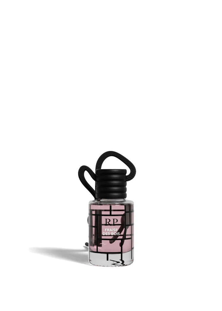 A small clear bottle of RP Lady Wonder perfume with a black cap and a black-and-pink geometric label, shown on a plain white background.FraiseDesBois