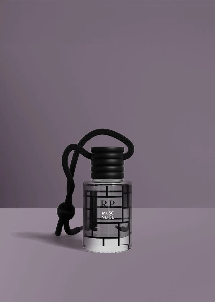 A small clear glass bottle with a black cap and black cord, labeled RP Musc Neige, set against a solid purple background.