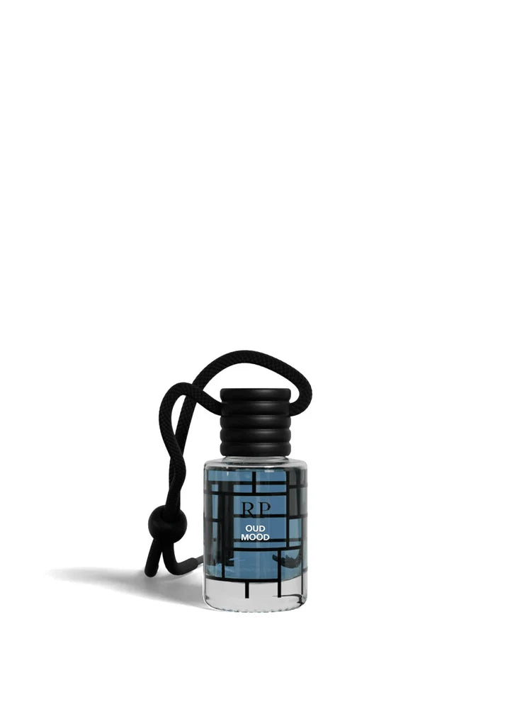 A small clear bottle of RP Old Fashion perfume with a black cap and black cord keychain, featuring a blue and black geometric pattern label, on a white background.