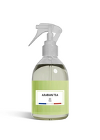 A clear plastic spray bottle filled with a pale green liquid, featuring a white spray trigger top and a light green label with a white label that reads 'ARABIAN TEA' and 'Sydney'.