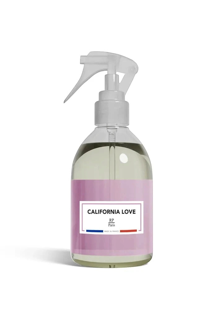 A clear plastic spray bottle filled with pale yellow liquid, featuring a lavender pink label with 'CALIFORNIA LOVE' and 'R.F.