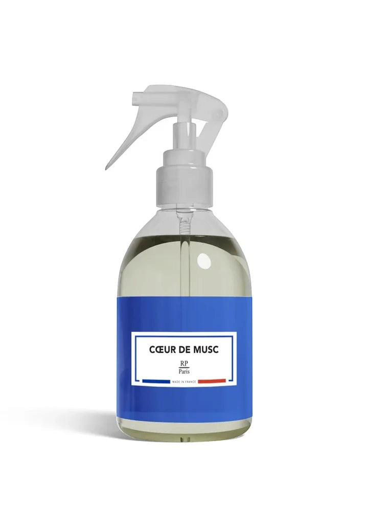 Clear spray bottle with a blue label on a white background