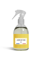Clear spray bottle with a yellow label on a white background