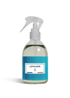 A clear plastic spray bottle filled with a pale yellow liquid, featuring a white trigger sprayer and a bright blue label with the text 'LOTUS SATIN' and 'BY Paris'.