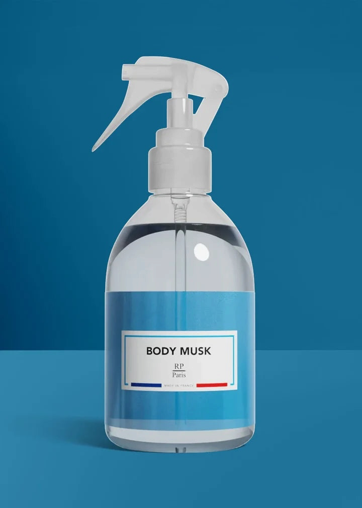 Clear spray bottle labeled 'BODY MUSK' on a blue background