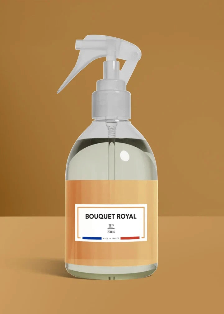Clear spray bottle with a brown label on a brown background