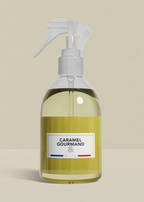 Clear spray bottle with a label on a beige background