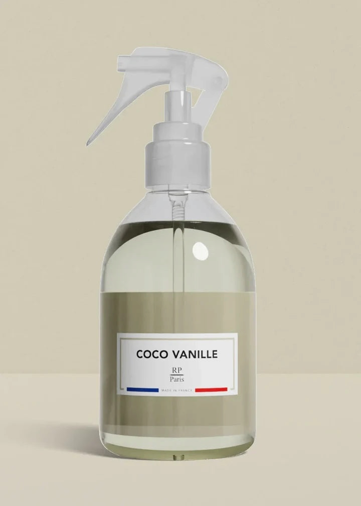 Clear spray bottle labeled 'Coco Vanille' on a beige background