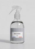 Clear spray bottle with a label on a gray background