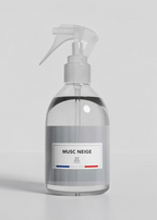 Clear spray bottle with a label on a gray background