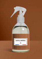 Spray bottle labeled 'Santal Imperial' on a brown background