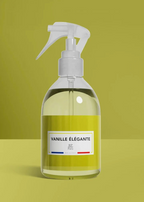 Clear spray bottle with a yellow label on a green background