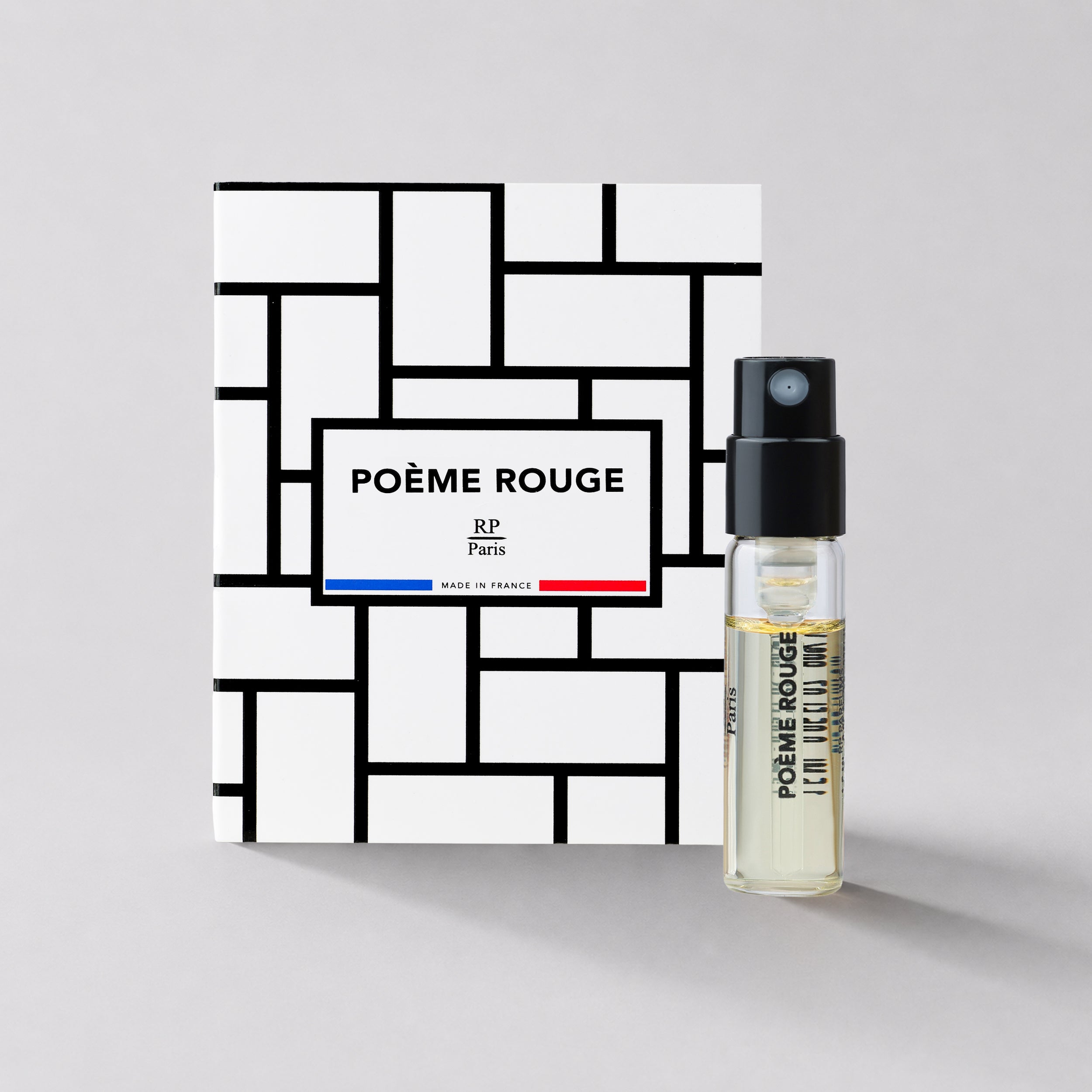 Poème Rouge perfume bottle and packaging on a light gray background